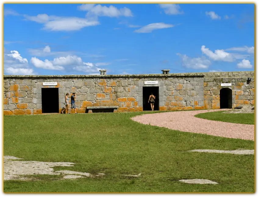 Visitors walking through the central courtyard of Santa Teresa Fortress surrounded by restored historic buildings